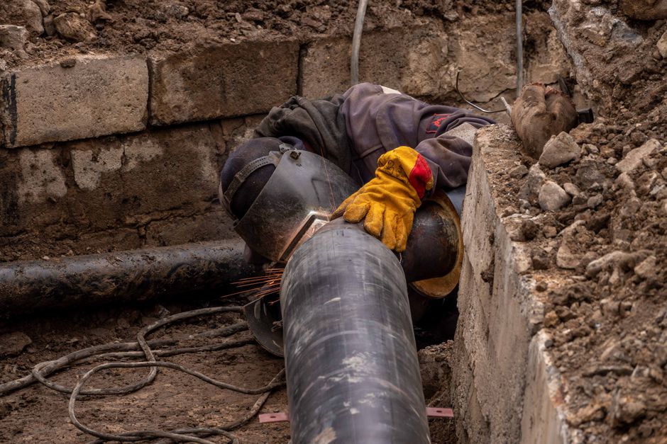 Close-up of a drainpipe being repaired in a residential garden in Kingston